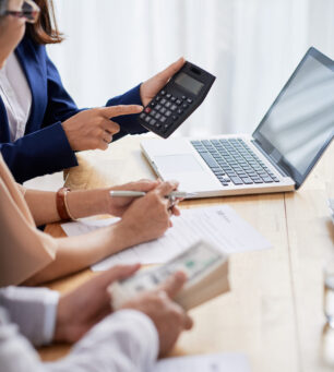 Calculating Mortgage Payment Real estate agent helping senior couple to calculate mortgage payment and down payment