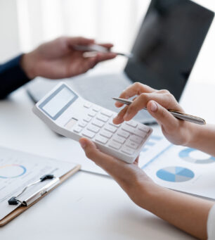Company meeting room has businessmen and finance managers meetin Company meeting room has businessmen and finance managers meeting together on finance topics, they are looking at information on documents and discussing together. Concept company financial management